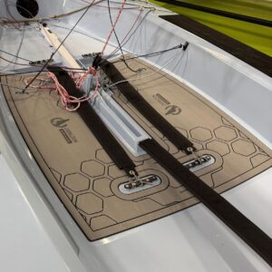 Close-up of a windsurf board deck with foot straps, tangled lines, and a non-slip pad area